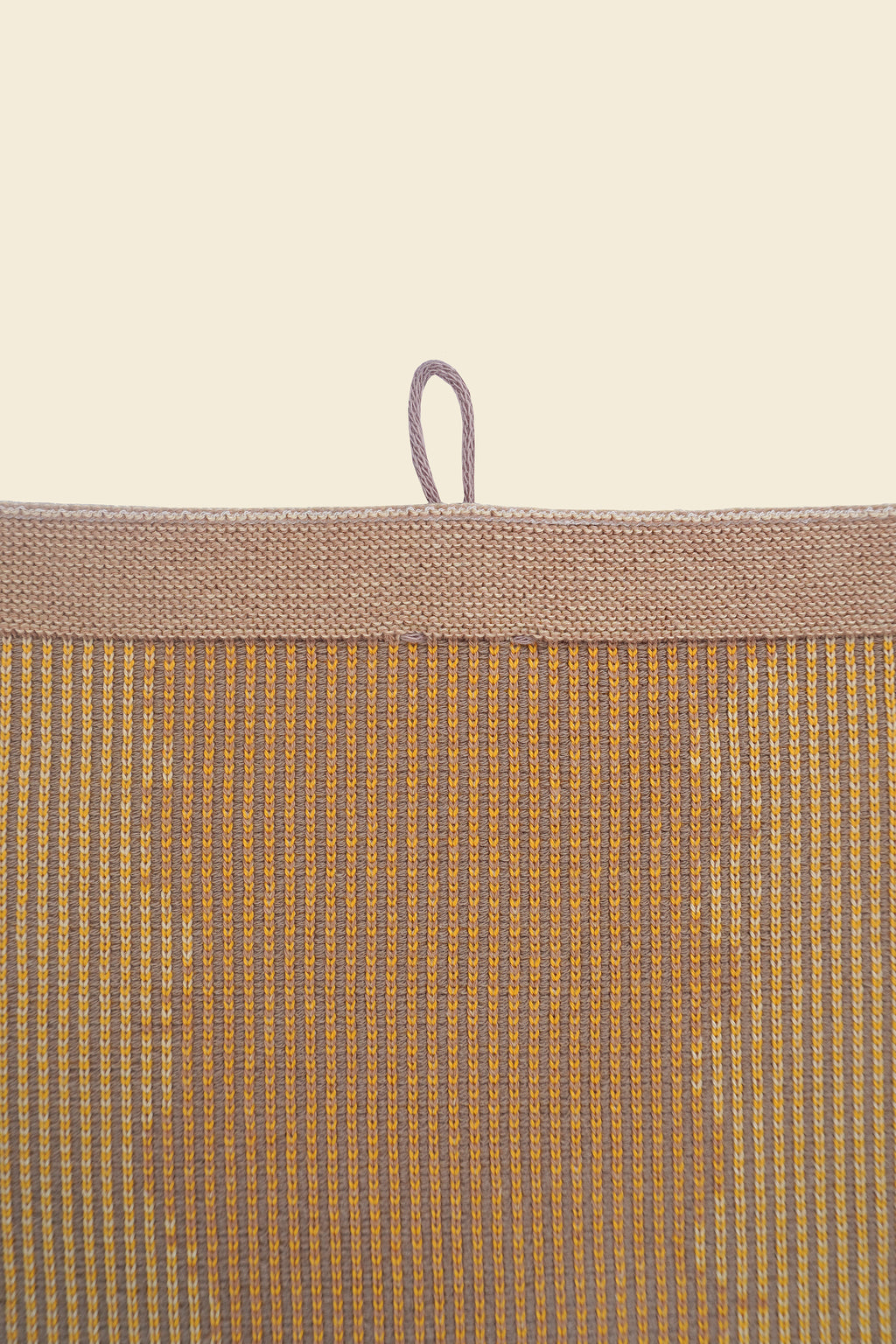 top detail of yellow knit organic cotton kitchen towel with wavy pattern