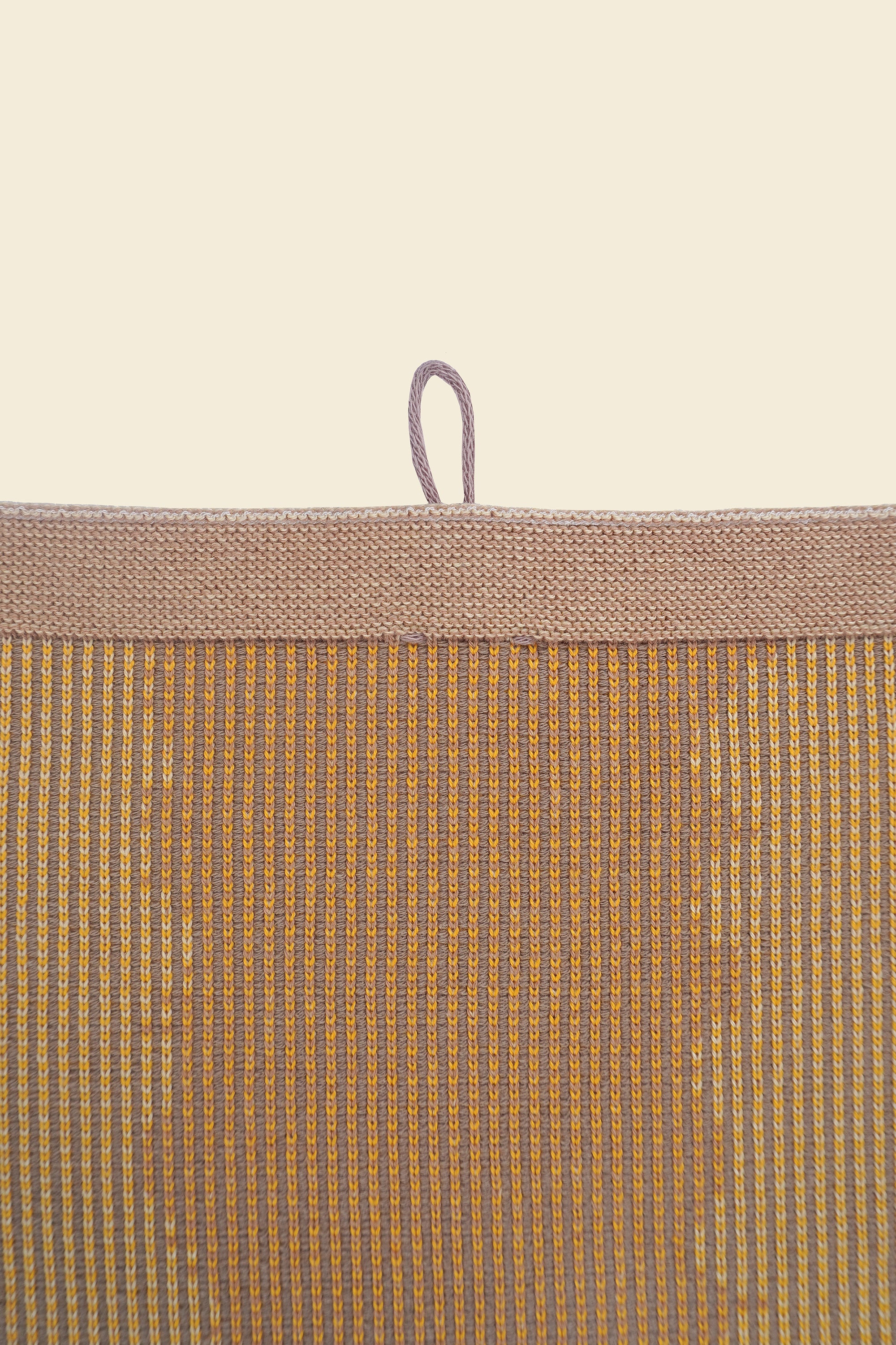 top detail of yellow knit organic cotton kitchen towel with wavy pattern