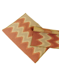 top view of red/gold knit table mat in organic cotton and viscose with wavy pattern