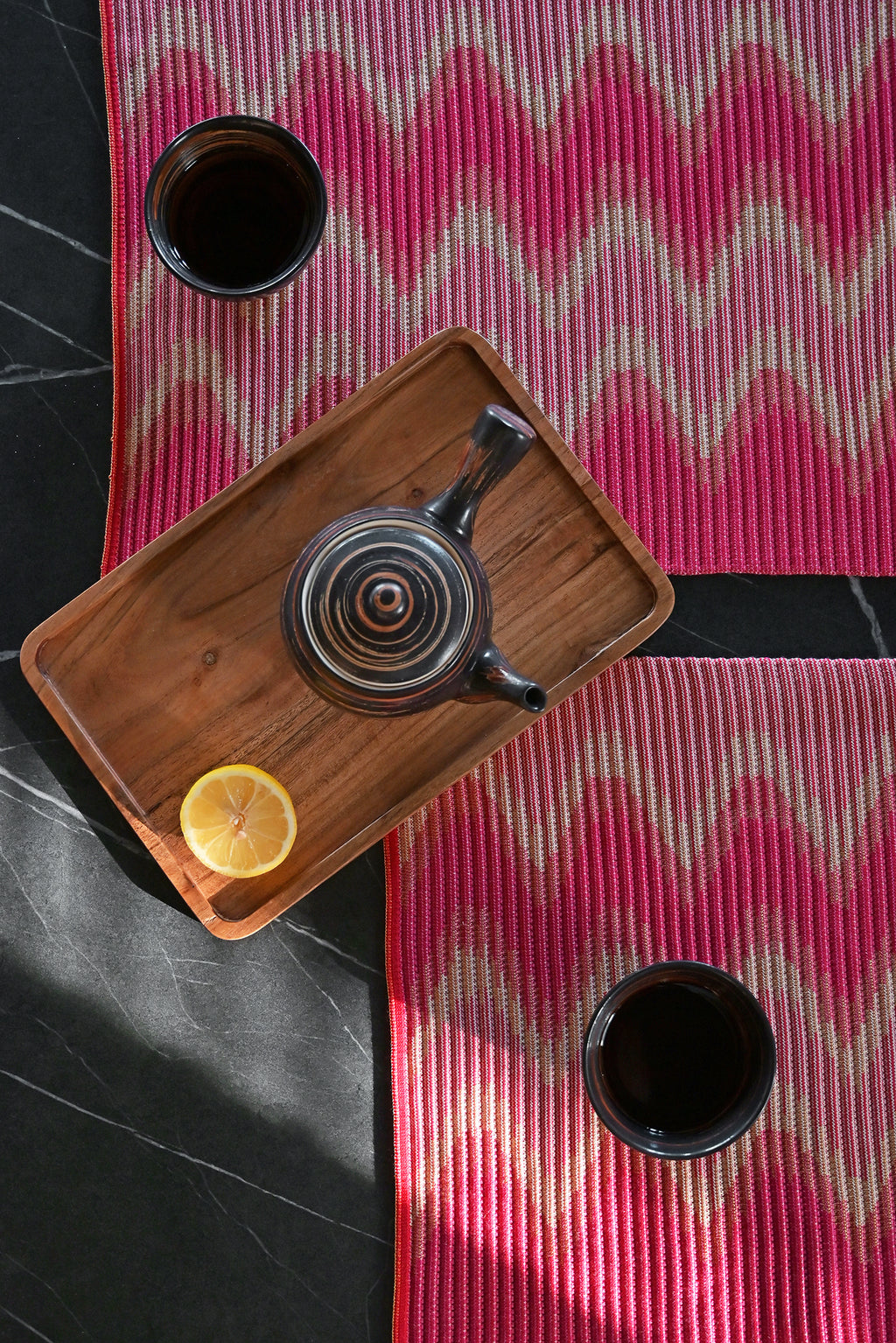 top detail view of red/yellow knit table mat in organic cotton and viscose with wavy pattern