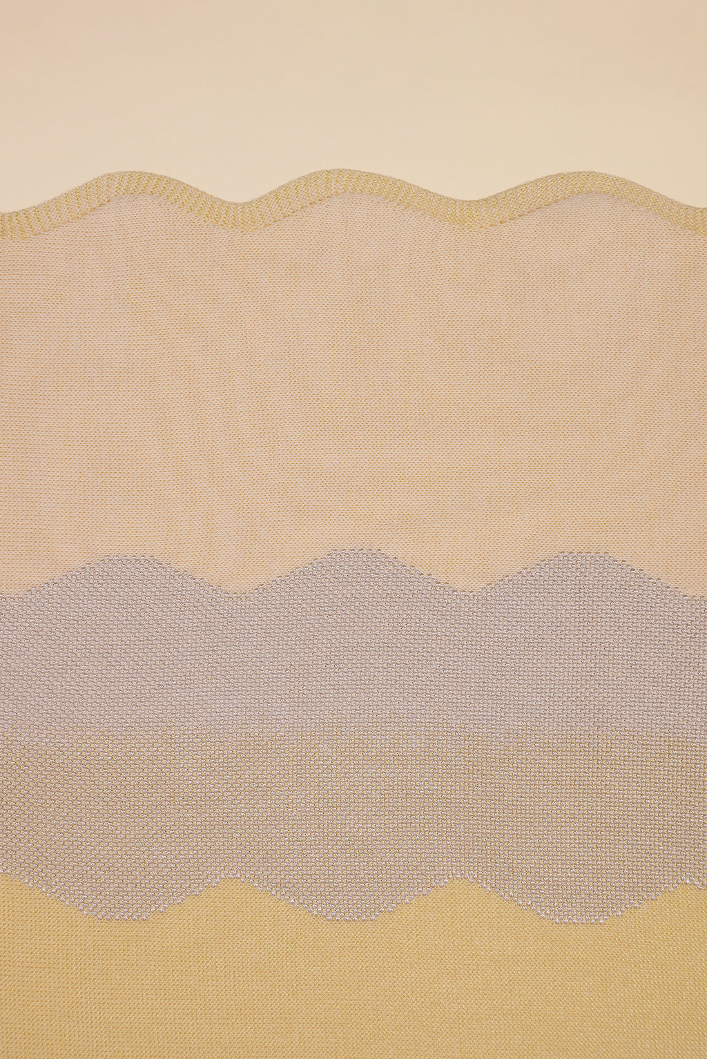 detail of wavy knit organic cotton table runner in yellow