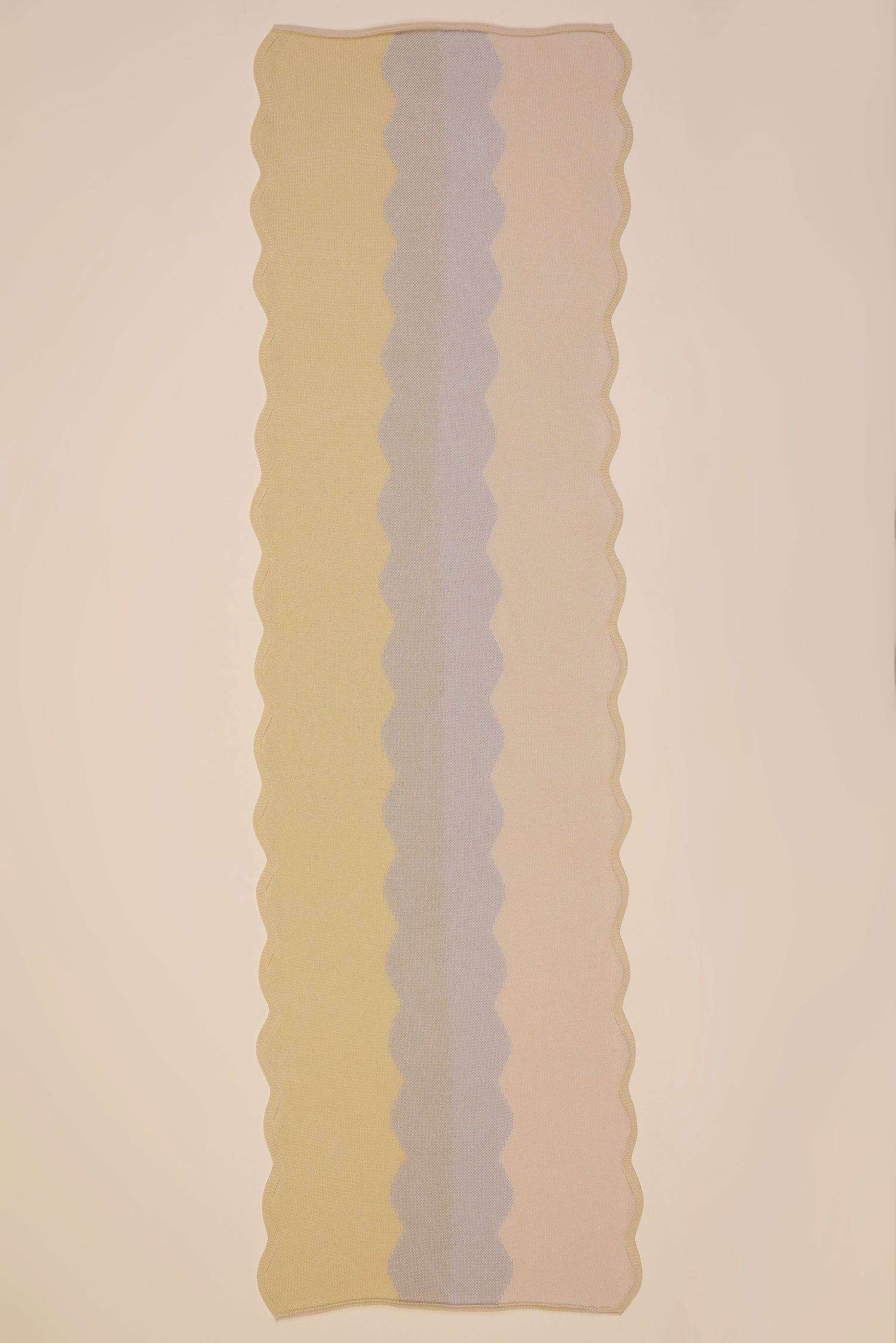 top view of wavy knit organic cotton table runner in yellow