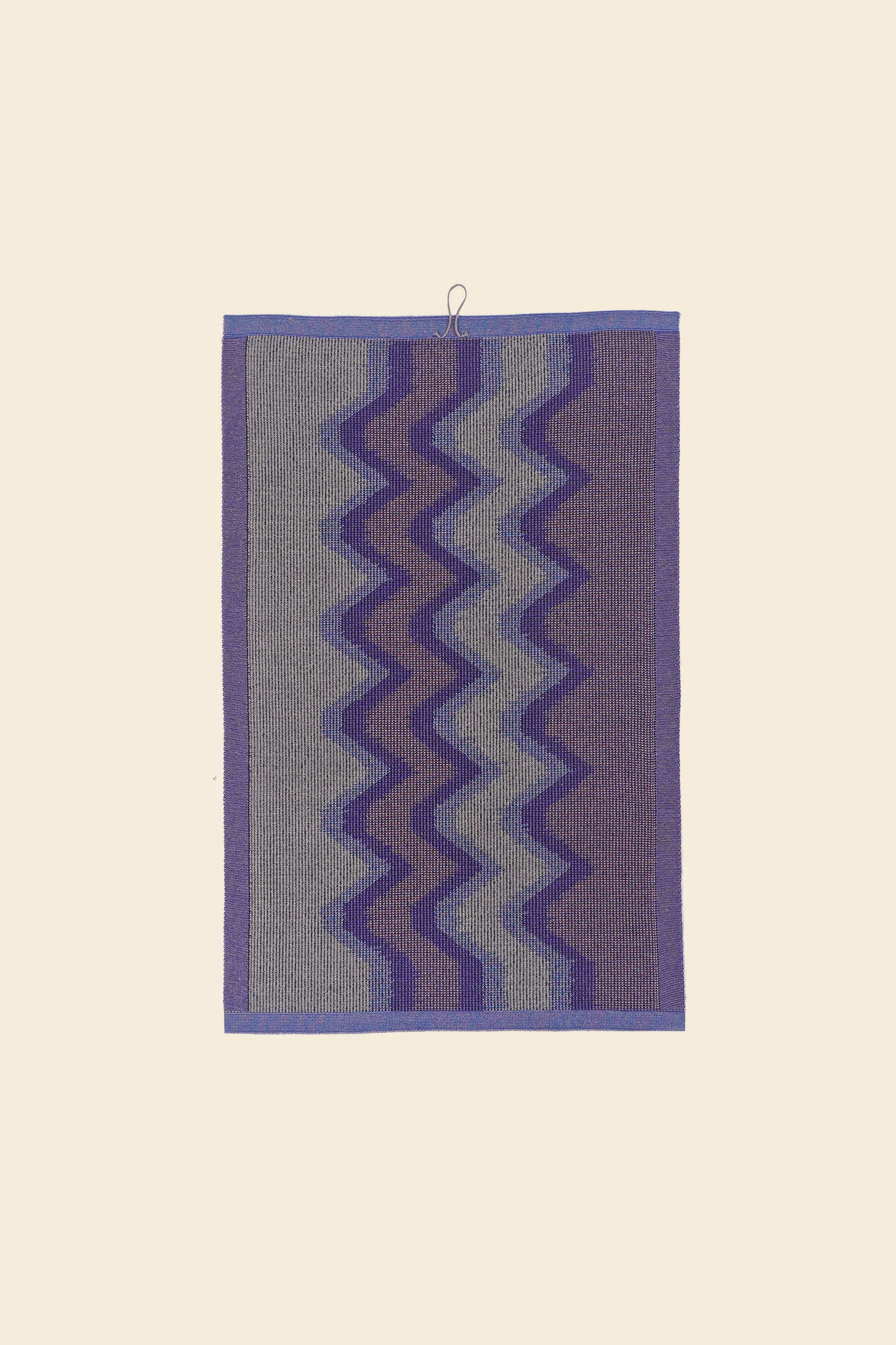 back side of purple knit organic cotton kitchen towel with zig zag pattern