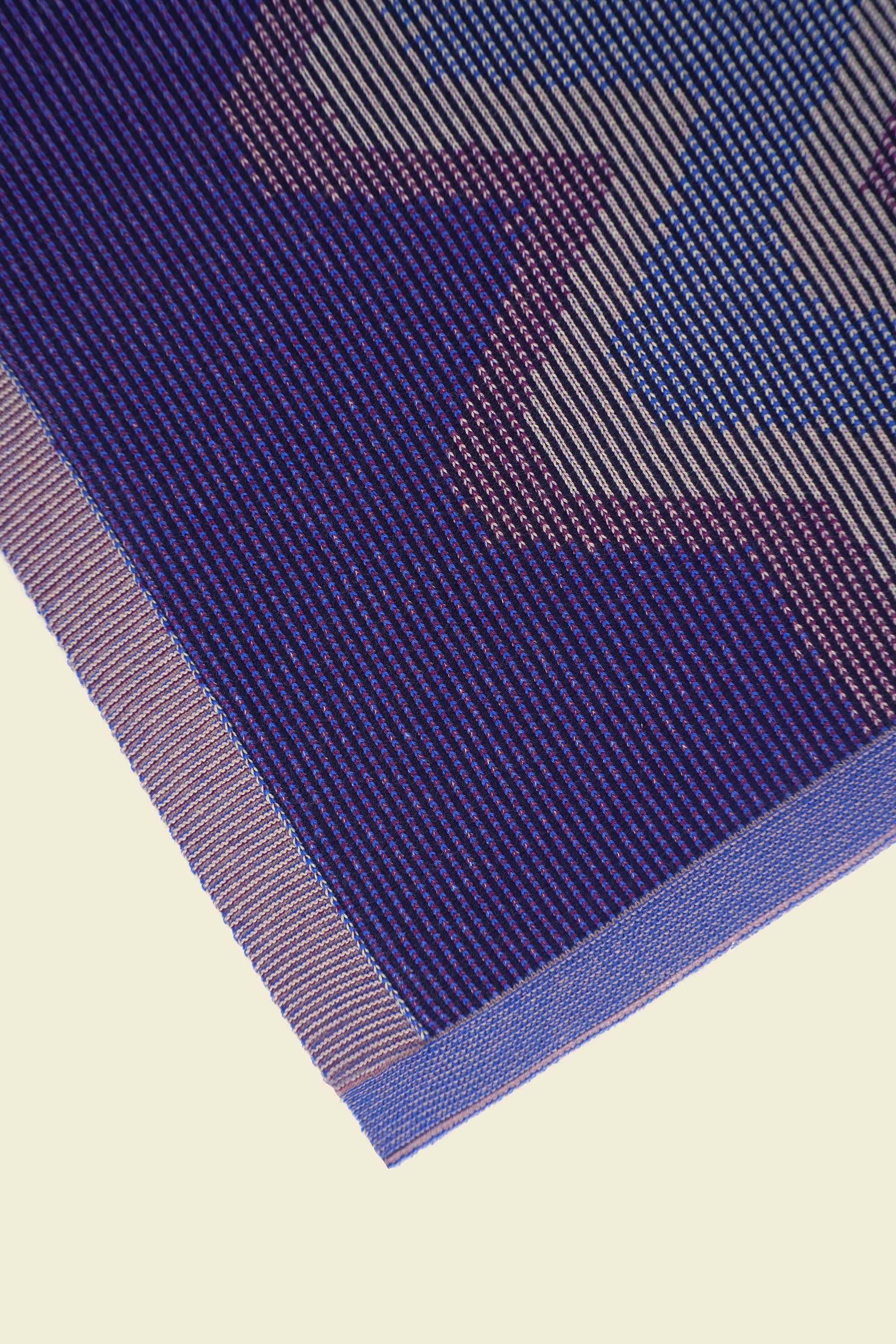 corner of purple knit organic cotton kitchen towel with zig zag pattern