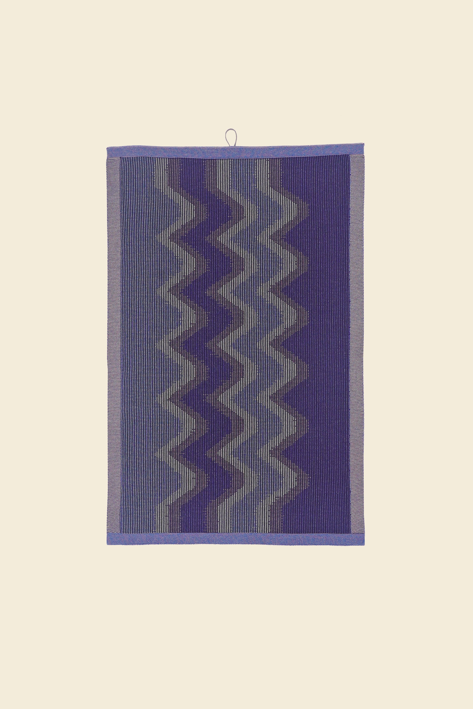 front view of purple knit organic cotton kitchen towel with zig zag pattern