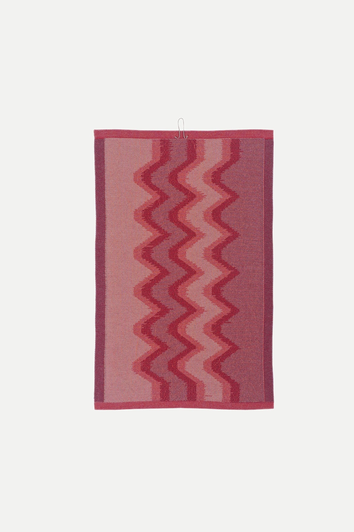 [red] deep red and mauve knit organic cotton kitchen towel, the second towel from the red zig zag set of 2, hanging flat