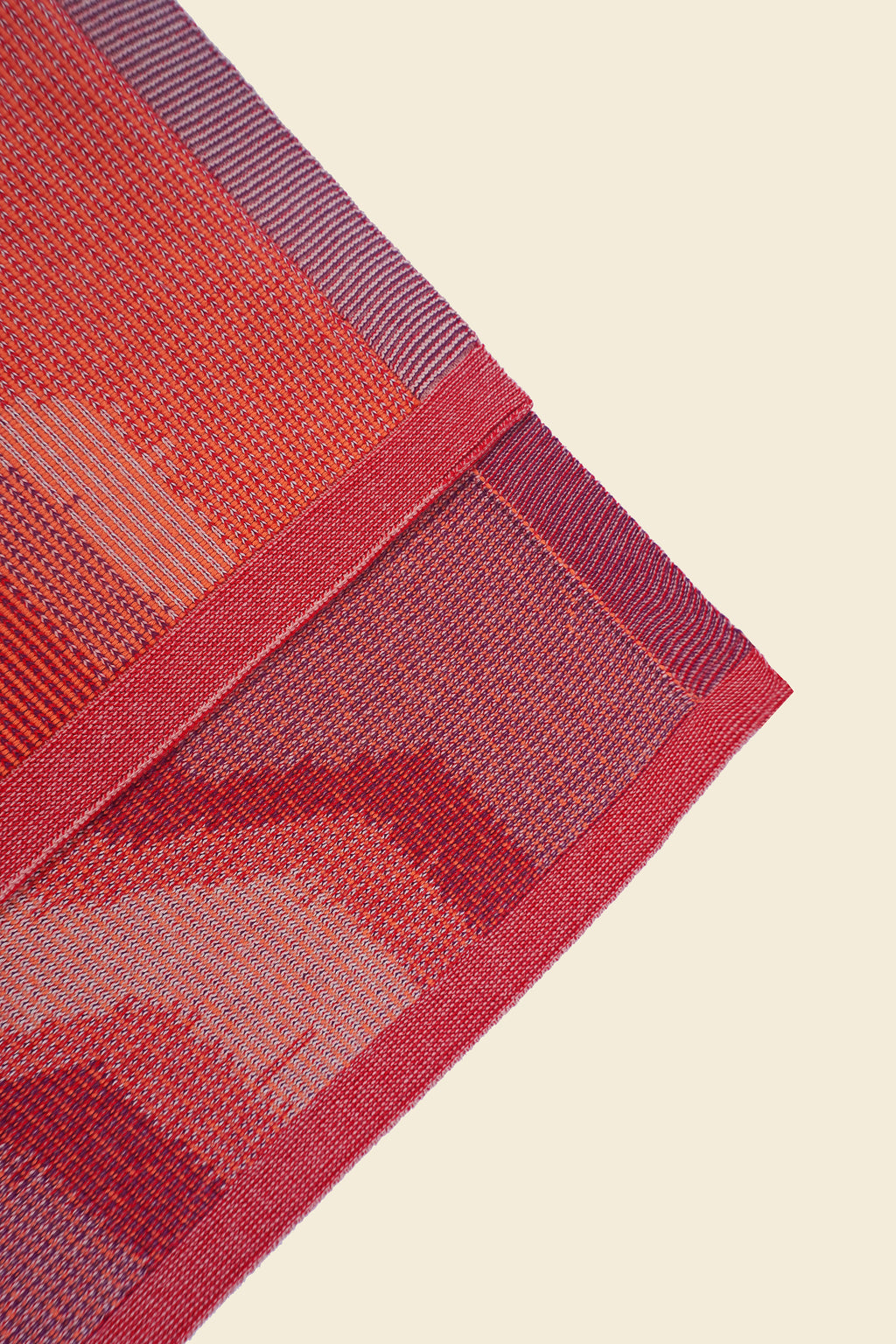 corner of red knit organic cotton kitchen towel set with zig zag pattern