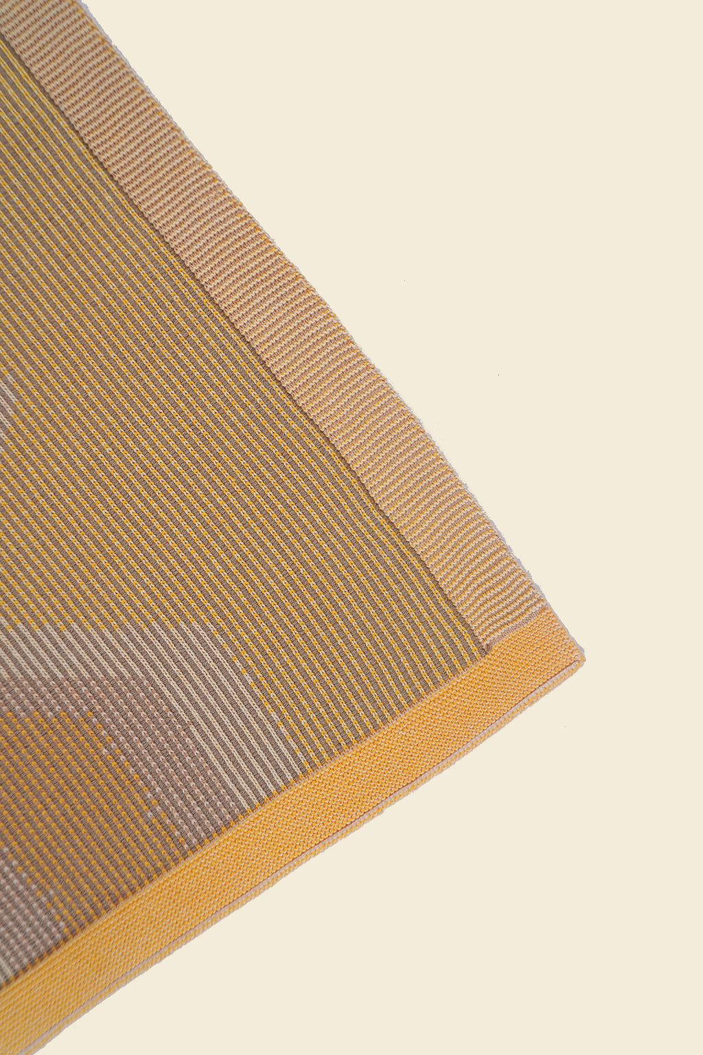 corner of yellow knit organic cotton kitchen towel with zig zag pattern